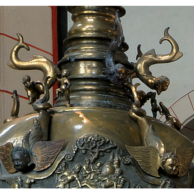 a number of monsters consisting of a winged human head and the body of a fish -- the larger ones fill the spandrels created by the Biblical scenes around the lower side of the font cover