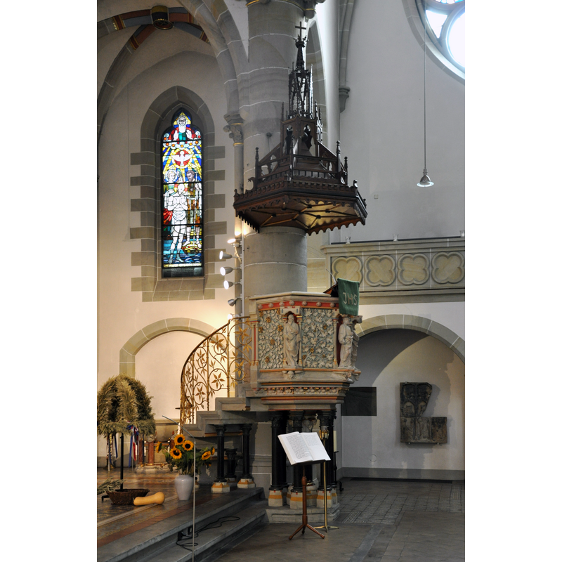 notice in the recessed arch, on the wall behind and to the right of the pulpit, the relief fragment from the earlier chapel