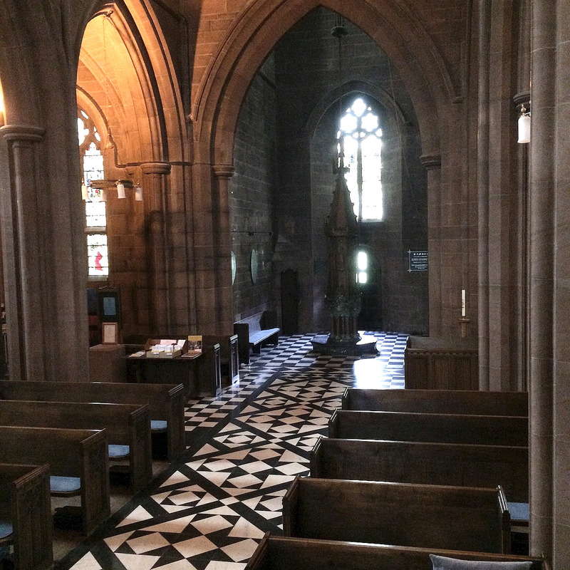 the modern font and cover in the modern baptistery of the Victorian High Gothic church