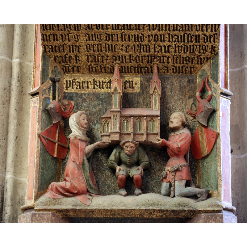 moving the church onto Heinrich Parler's back -- Source caption: "Grundsteinrelief: Altbürgermeister Lutz Kraft und seine Frau übertragen Heinrich Parler 1377 die Verantwortung für den Bau der neuen Pfarrkirche, Ulmer Münster".