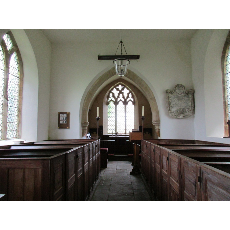 Source caption: "Interior looking east, St. John the Baptist, Plumpton. The fittings largely date from the rebuilding of the church in 1822."