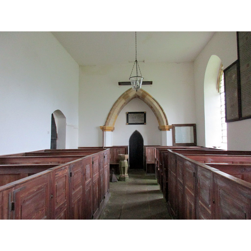 Source caption: "Interior looking west, St. John the Baptist, Plumpton. The fittings largely date from the rebuilding of the church in 1822."