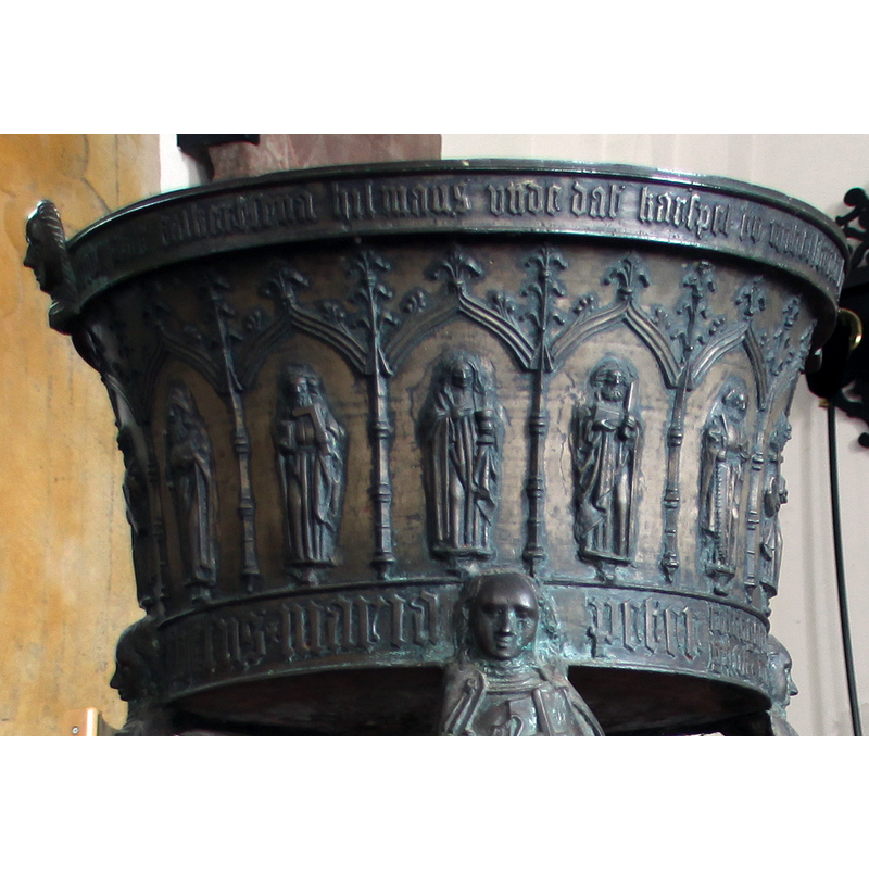 each carrying the symbol that identifies him: square (Thomas or James, son of Alphaeus), chalice (John), flaying knife (Bartholomew), saw (James the Lesser), etc.