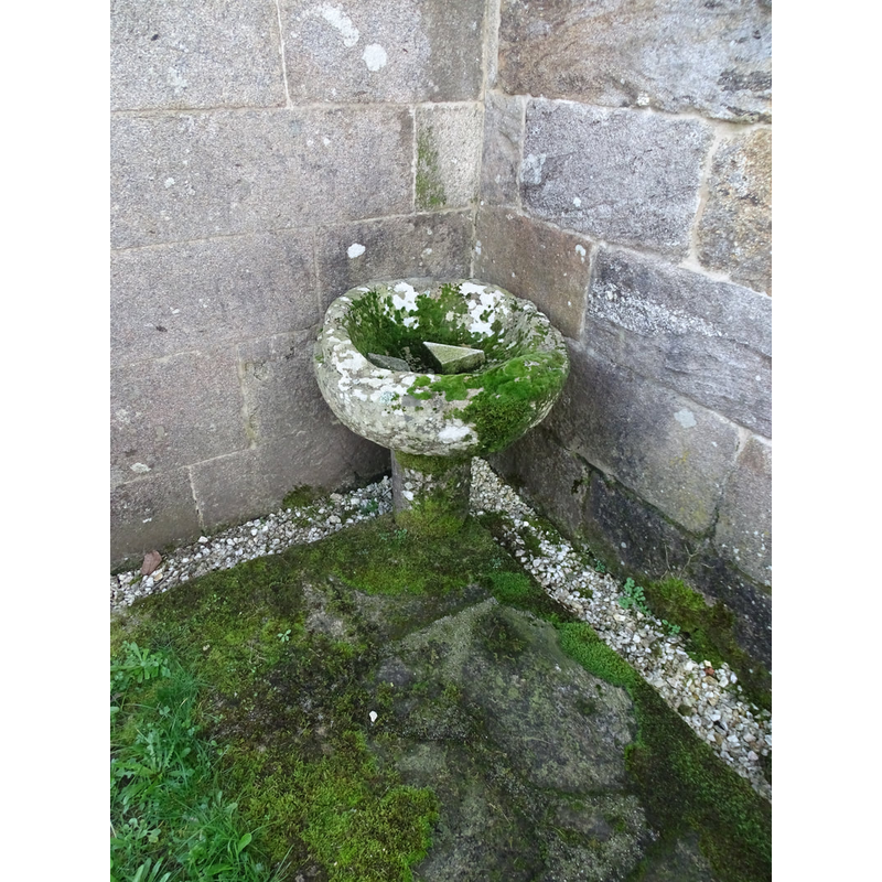 disused font located outside the church