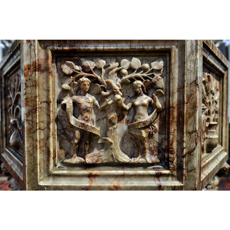 the modern alabaster font; the west panel shows the Temptation and Fall, Adam and Eve's pudenda conveniently cover by inscribed scrolls