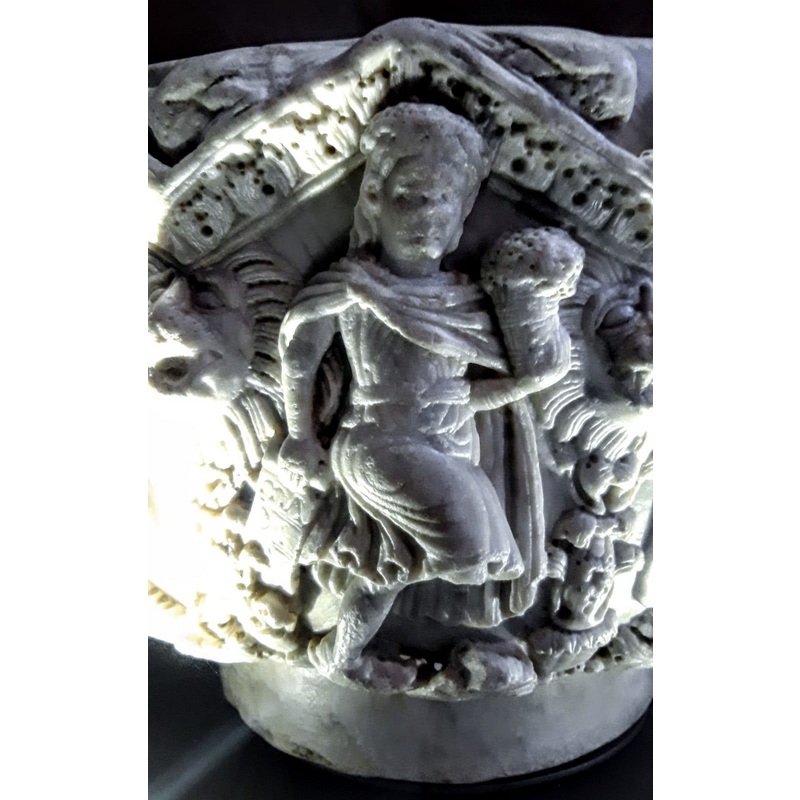 human figure carrying a basket of flowers