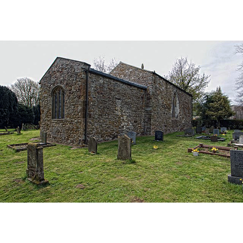 the fragment of an earlier window is discernible in the centre of the chancel wall, in the eastern half of the body of the church