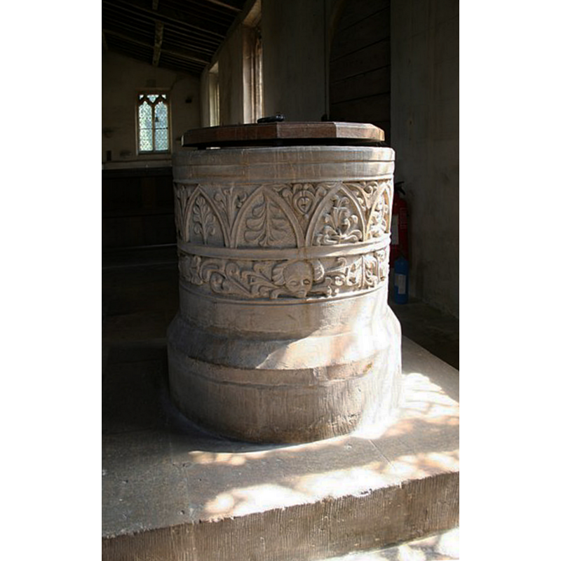 Source caption; "Norman tub font with faces and foliage, badly re-cut in the 18th century".