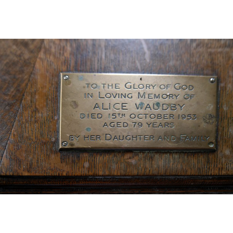 Source caption: "Saint Nicholas, Walcot: dedicatory plaque on font cover. A simple hexagonal oak cover on the font, dating, as the plaque says, to 1953." [NB: the cover is dodecagonal]