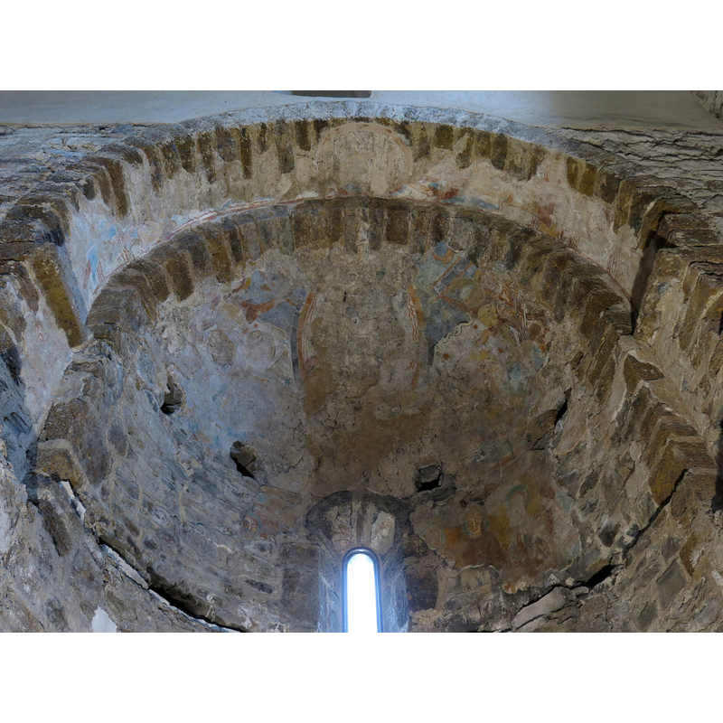 interior view of the monastic church of Sant Quirze: the south apse with mural painting remains