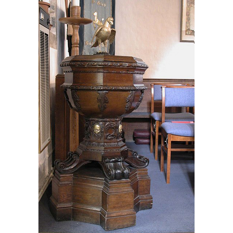 the rather eerie decoration on the stem of the font