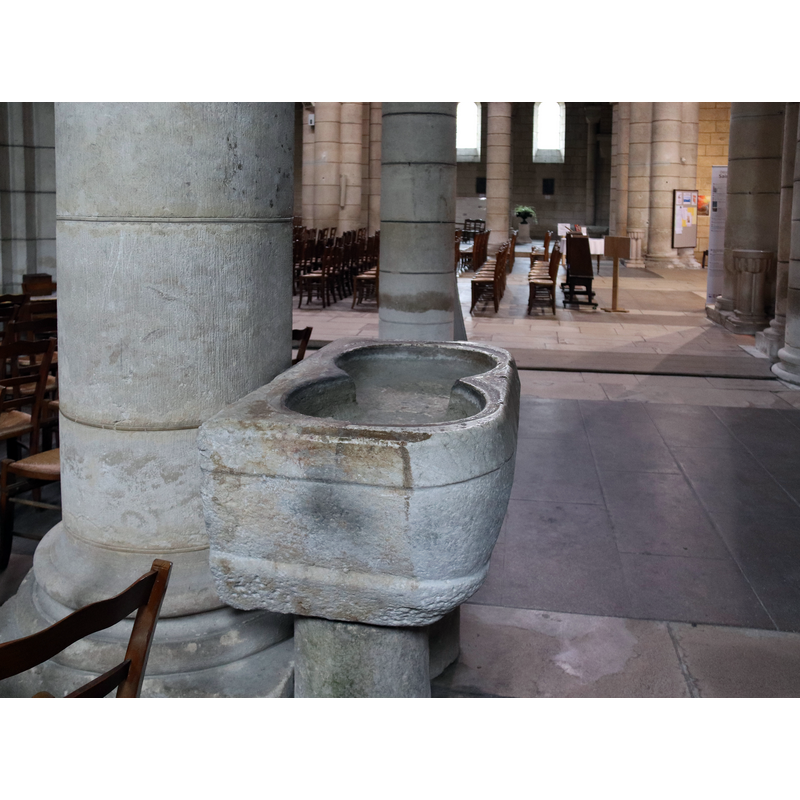 the upper half appears to be a former font, now raised on a capital, in the churchyard