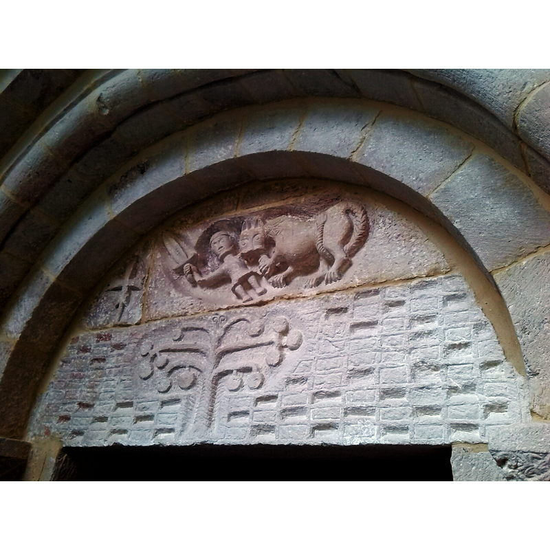 presumably St Michael the Archangel, patron saint of this church, but the beast is definitely a lion -lovely rendered tail- that seems to be giving the sword-wielding angel a good fight