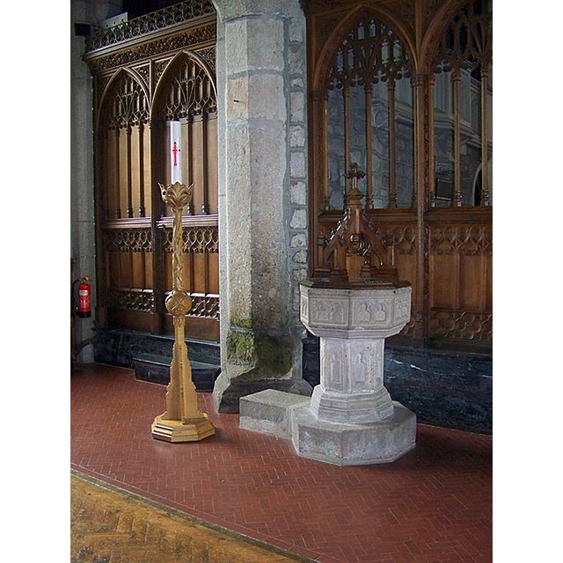 Source caption: "St Andrew's Church, Moretonhampstead. The font is made of granite and seems to have survived the centuries intact and is a good example of a 15th century octagonal font. The panels and shaft are decorated with shallow niches. The font cover is not original".