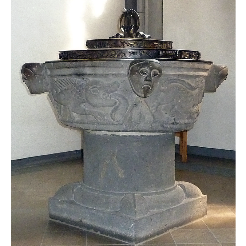 showing three heads, with a marine monster in the left panel, and a lion passant in the right one
