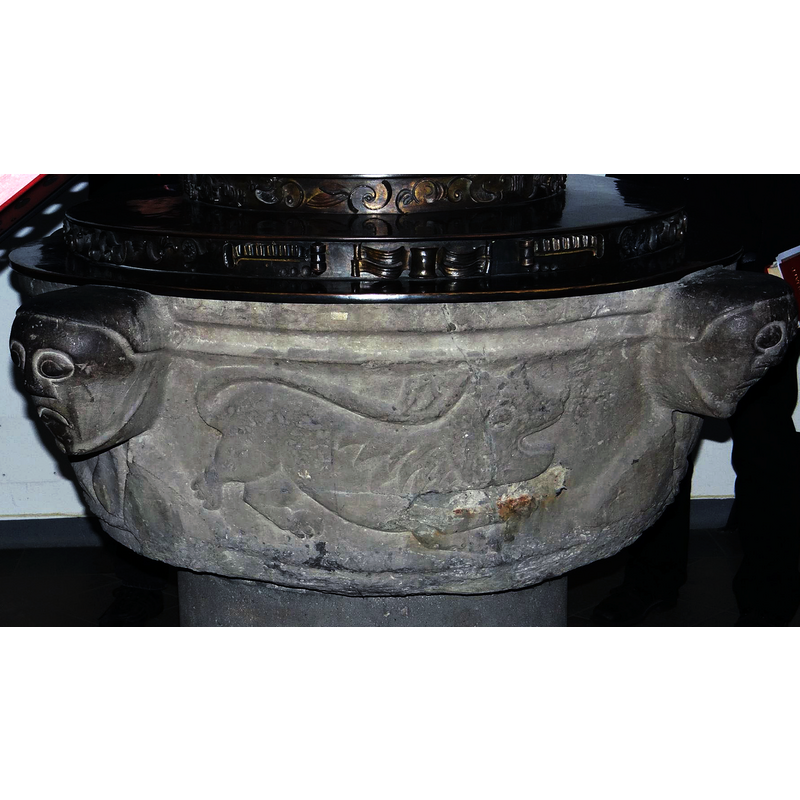 notice the damage to the stone beloww the head