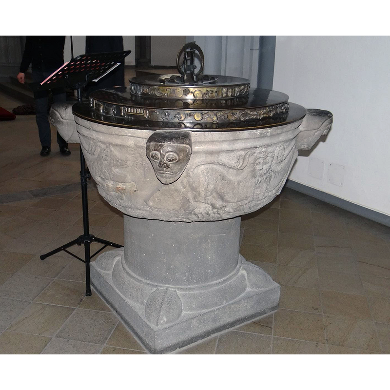 showing three of the heads and, on the left panel, a lion, on the right a bicorporate lion, although the head appears to be two joined -- the cover and the pedestal base are modern