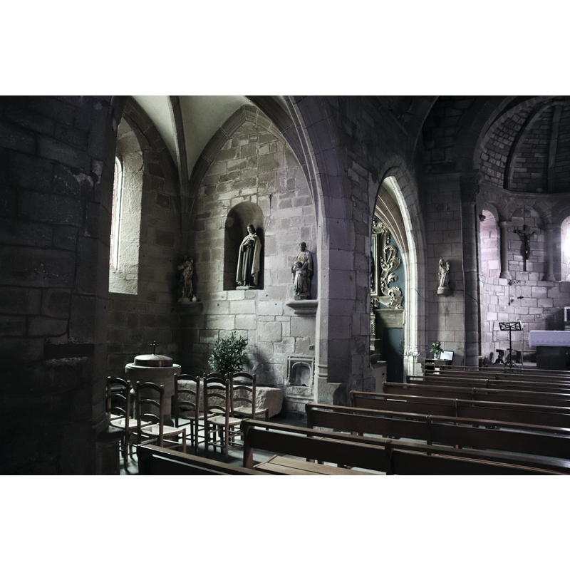 showing the baptismal font in one of the north-side chapels
