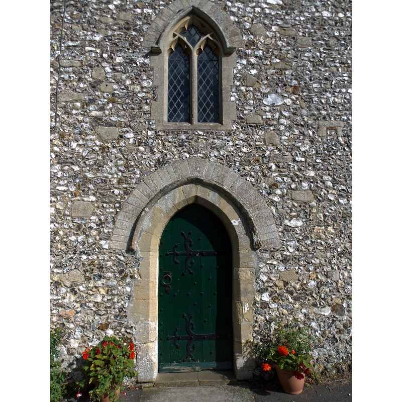 Source caption: "West door and window of the nave of Holy Trinity parish church in Nuffield, Oxfordshire, England."