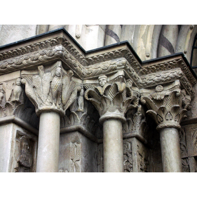 The musem information suggests that the decorative motifs hark back at 11th-century stucco models, and later used on the south portal of Grossmünster, in Zurich, the latter shown in this photograph of the capitals of the west side of the south portal.