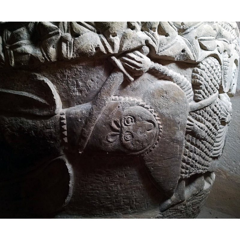 the warrior is wears in coat-of-mail armour covering his body; arms and head; he strikes the monster with his sword while the beast bites into his long shield -- the whole scene, involving the two warriors and the monster, covers almost half the side of the basin, approximately from the north side all the way to the south