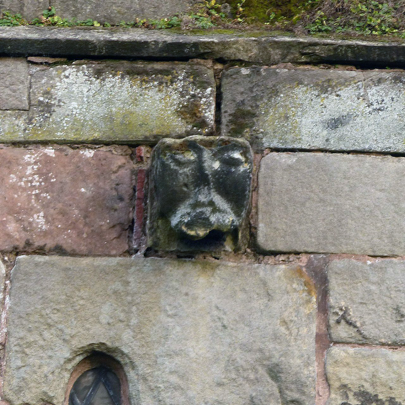 Source caption: "Norman period corbel on the west front."