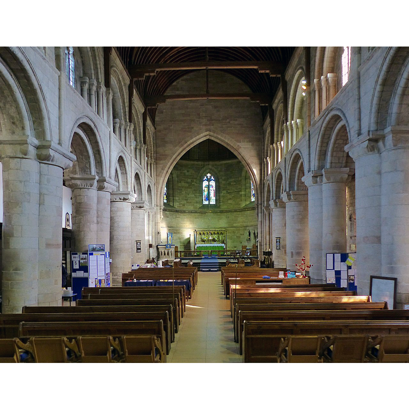 Source caption: "The interior looking east. Following the dismantling of the chancel and transepts after the Dissolution in 1538, the east end of the church was in the plane of the current chancel arch. This was created when Street added the chancel in 1868, the Gothic style contrasting with the Norman arcades of the nave. The chancel was not part of Street's initial restoration work of 1867 but was added as the gift of Sir Oswald Mosley of Rolleston Hall."