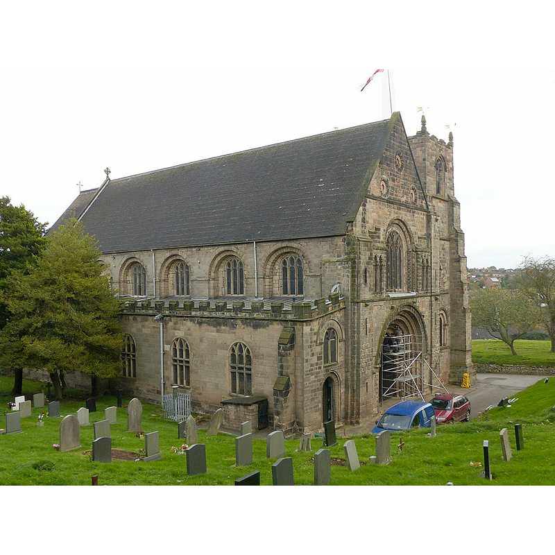 Source caption: "Church of St Mary, Tutbury. View from the north west. The higher ground of the churchyard helps to give a view of the bulk of the church. One has to imagine it stretching as far again to the left, with transepts and a central tower, as the original priory church."