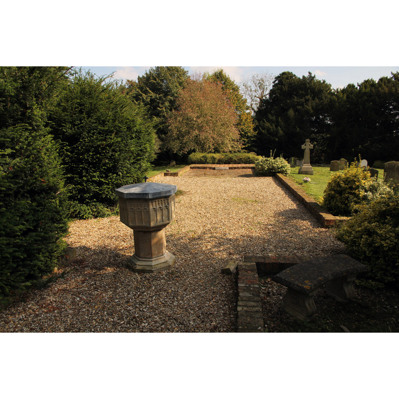 Source caption; "Site of St.Edith's church. The octagonal Perpendicular font and ground plan in brick edging is all that remains of St.Edith's church at South Carlton. A church built of chalk in Little Carlton was recorded in the Domesday book of 1086. The church was rebuilt in 1837 using the original materials. The last service and christening was held in October 1978 and the last Carol service in December 1978. The church was declared redundant in 1981 and demolished in 1993."
