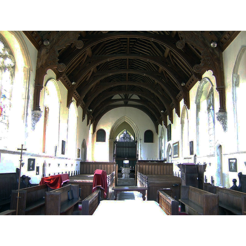 showing the font at the far back, beneath the tower arch