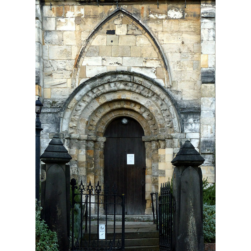 Source caption: "Church of St Denys, south doorway. The church was essentially entirely rebuilt in the 14th and 15th centuries, but this mid-12th century Norman doorway was reset when this was done."
