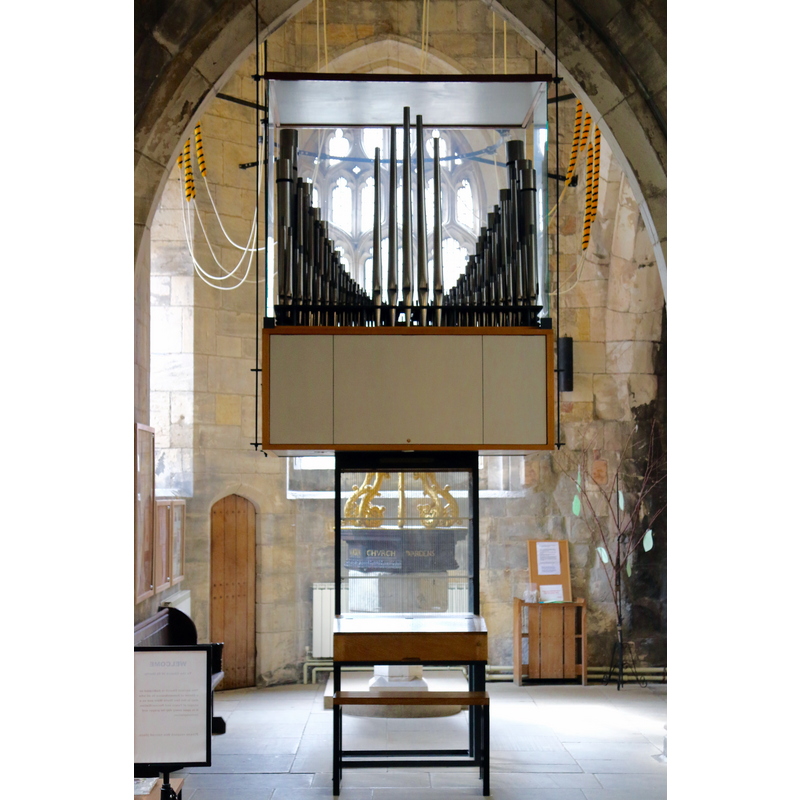 the font and cover partially visible behind the organ