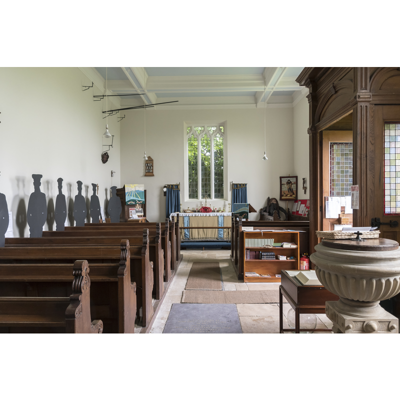 the modern church showing the modern font by the entranceway