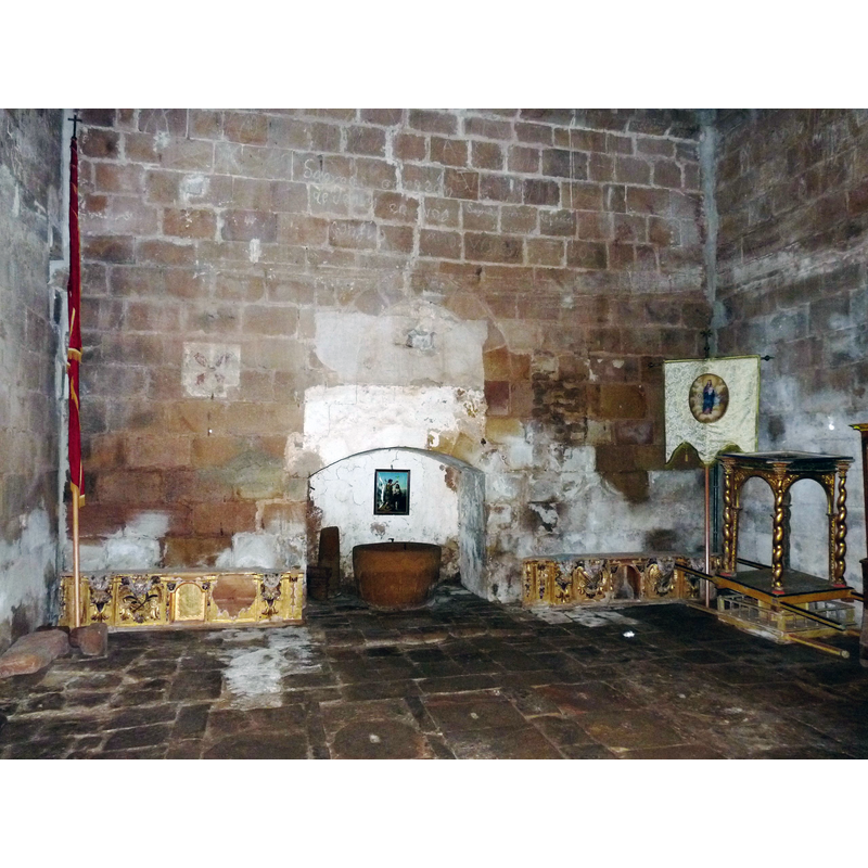 the position of this font suggests a hearth with a large cooking pot rather than a baptistery