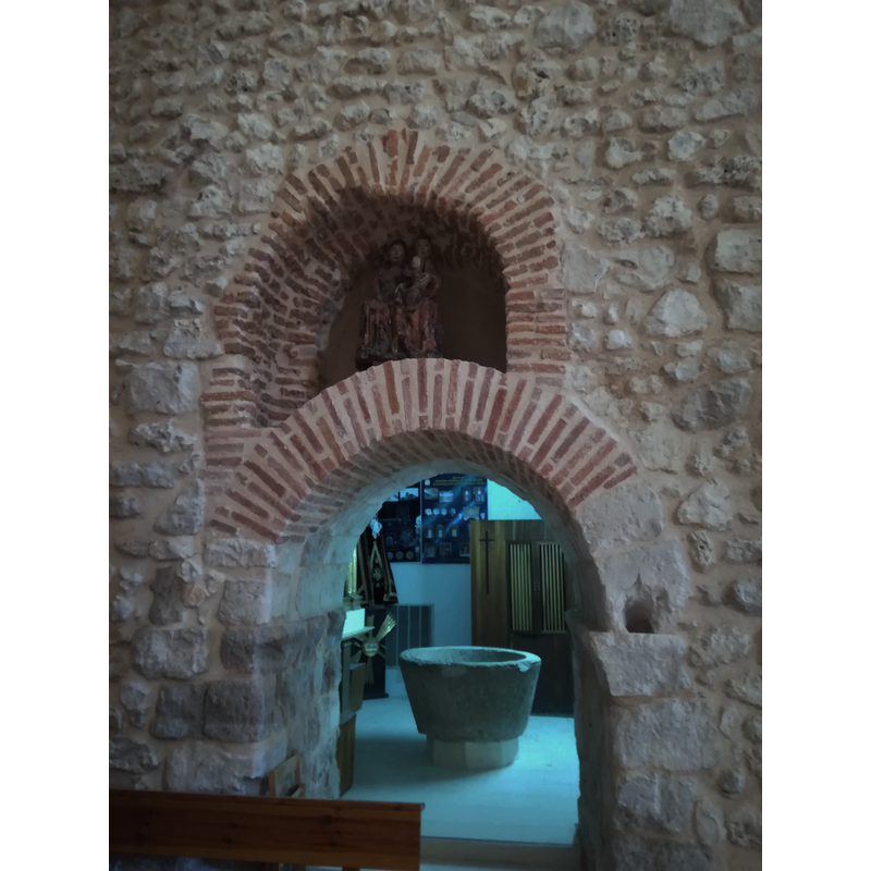 behind the arched doorway is the Capilla de San Pedro Regalado, inside which is the font