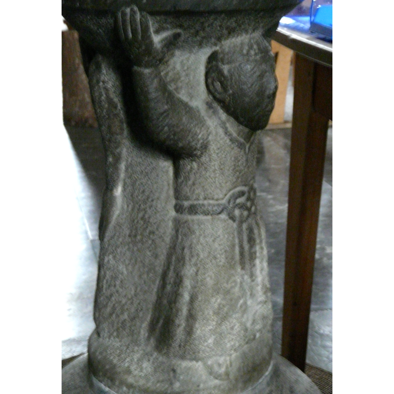 notice the fancy knot in his belt; long robe; tips of the feet showing