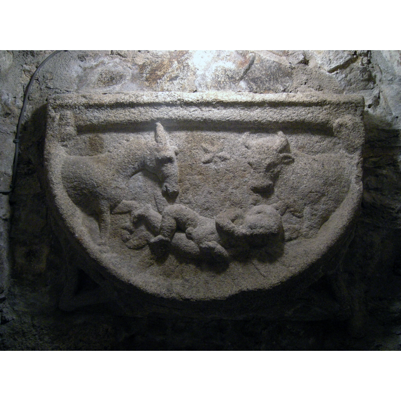 this relief, in what appears to be the front part of a cushion capital, shows a partial view of a Nativity scene -- the piece is late, probably late-15th or 16thC [HST suggested dating] and the 'baptistery' where it is located appears to be totally made up -- the font is modern