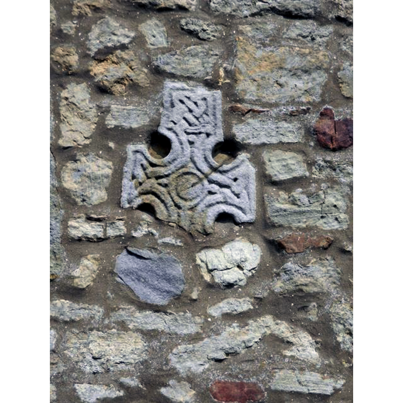 Source caption: "Celtic Cross, old head by the off-road path, in parish of Sinnington (Ryedale District), built into the S wall of the church and in West doorway, two complete stone cross heads of very different design in the middle of the outer wall; cross fragments used as part of in-fill for West Door."