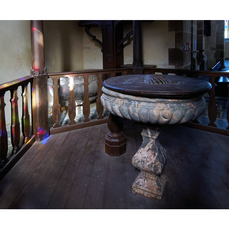 in the foreground is the main later font; in the background, behind the railing, is the object now used as stoup but perhaps the original font of this church