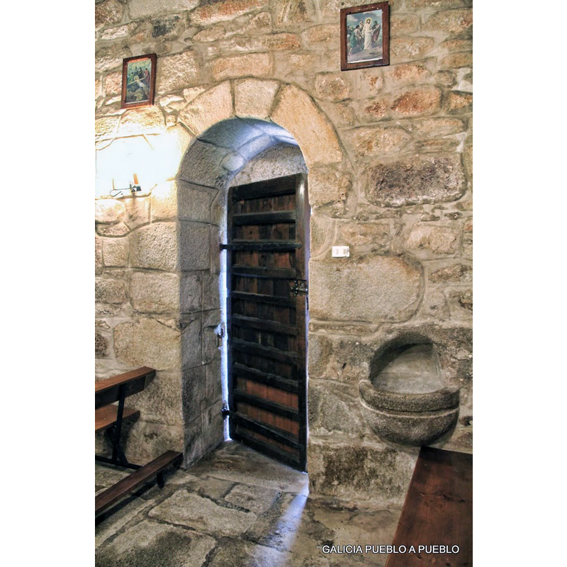 showing the large wall-mounted holy-water stoup to the west of it