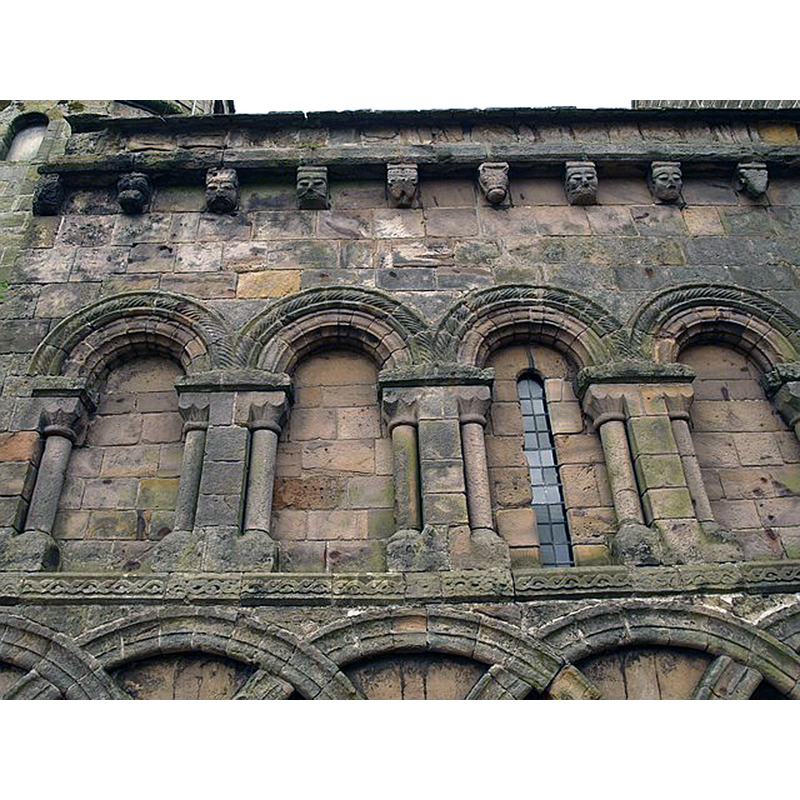 Source caption: "St Athernase church, Leuchars. The north wall of the apse, showing the remarkable Romanesque decoration of blind arcades and grotesque heads."