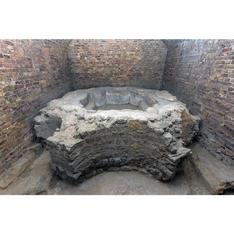 ruins of the baptismal font from a free-standing 7th-century baptistery existed in what is now the east end of the cathedral; the baptistery itself was demolished in the 9th century -- one of the 'radial' protrusions from the font, seen here in the bottom right corner appears hollow; it might have been one of the drainage or intake conduits for the water