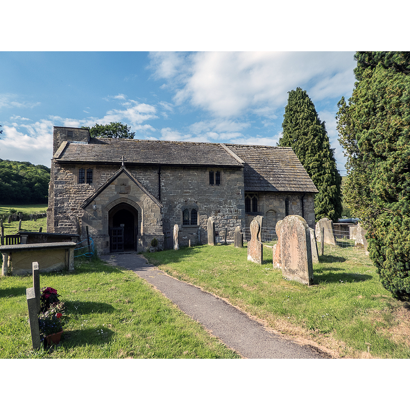 Source caption: "The church dates as far back as 1050AD with some parts as old as 850AD. As you enter the church you see the font under the West window. The font, like the stone altar in the chancel, are the oldest parts of the church"