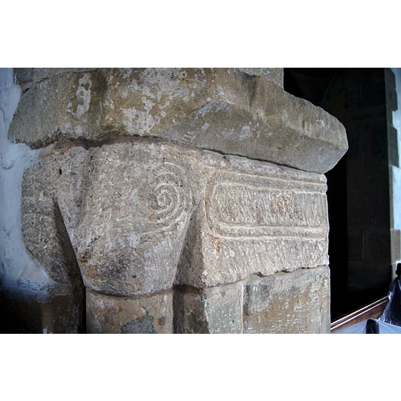 Source caption: "The chancel arch capitals are extremely crude. Spirals are the predominant decoration at this church - a decorative form almost as old as mankind."
