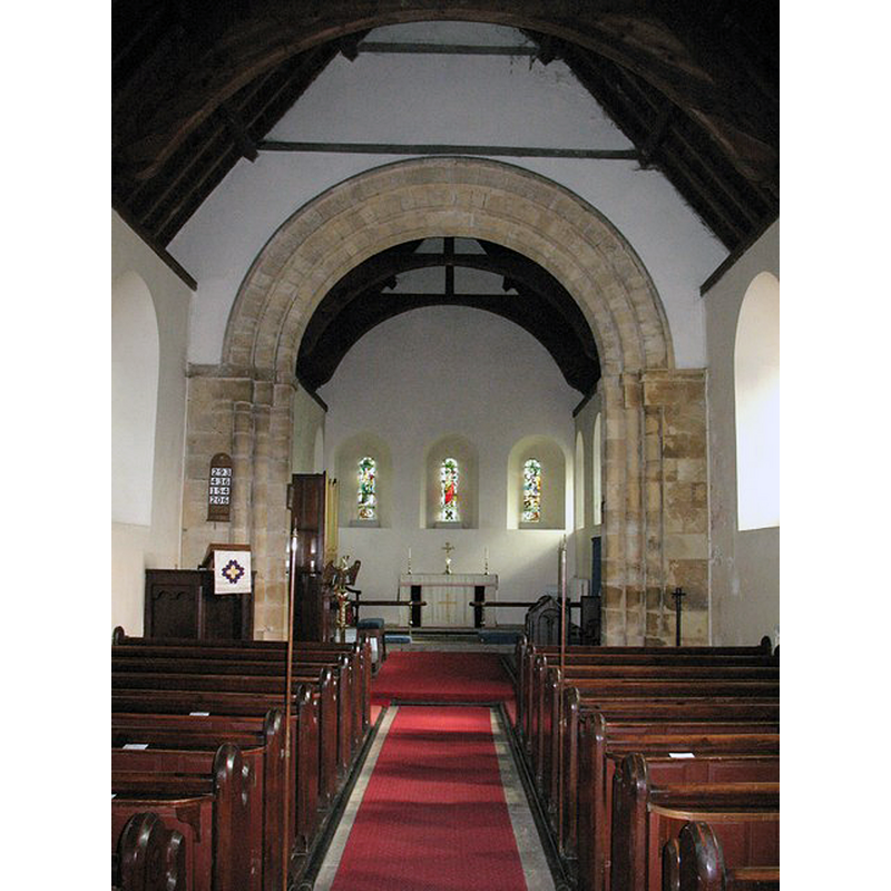 Source caption: "The nave of St Martin's church with its restored Norman chancel arch."