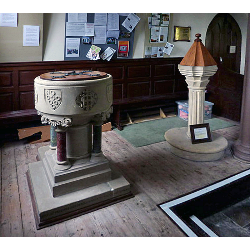 Showing the two fonts: on the left the one donated by G Brown in 1891; on the right the font of the 1818 replacement church; the medieval church was demolished when its foundations were compromised by the nearby beck; we have no information on its font