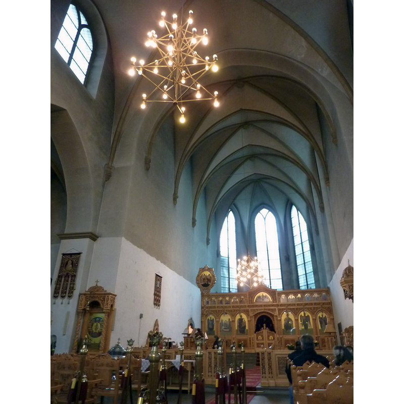 a modern (?) metal font is discernible among the pews/benches on the left