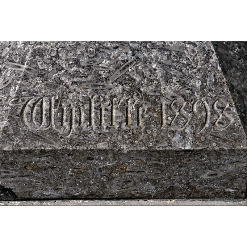 with the inscription "Wycliffe 1898" on the lower base of the modern font -- notice the high fossil content of the stone