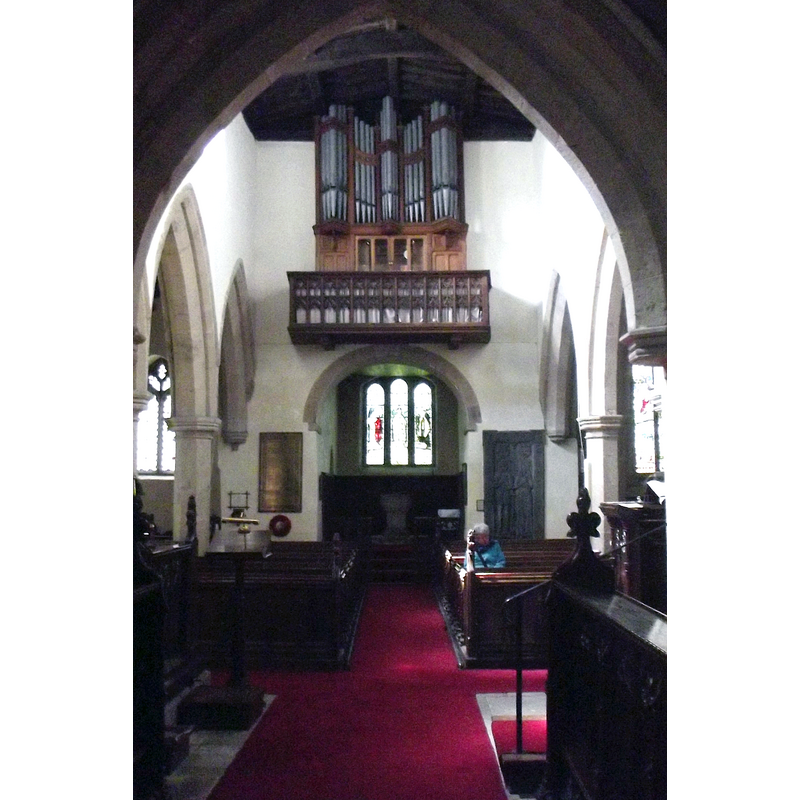 Source caption: "Looking west in St Agatha's Church. At the left it can be seen how the 14th-century aisle is extended westwards beyond the nave, to overlap the Norman tower. The round-headed tower arch is "probably an enlargement of an earlier opening" according to the church guide - maybe replacing the original Saxon work."