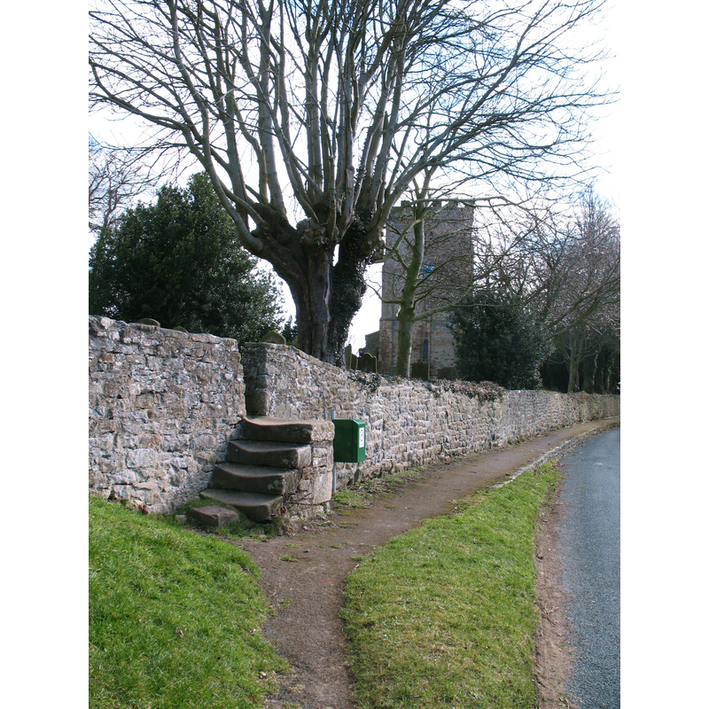 Source caption: "Worn steps into the churchyard on Church Row, Melsonby. Church of St James in the background"